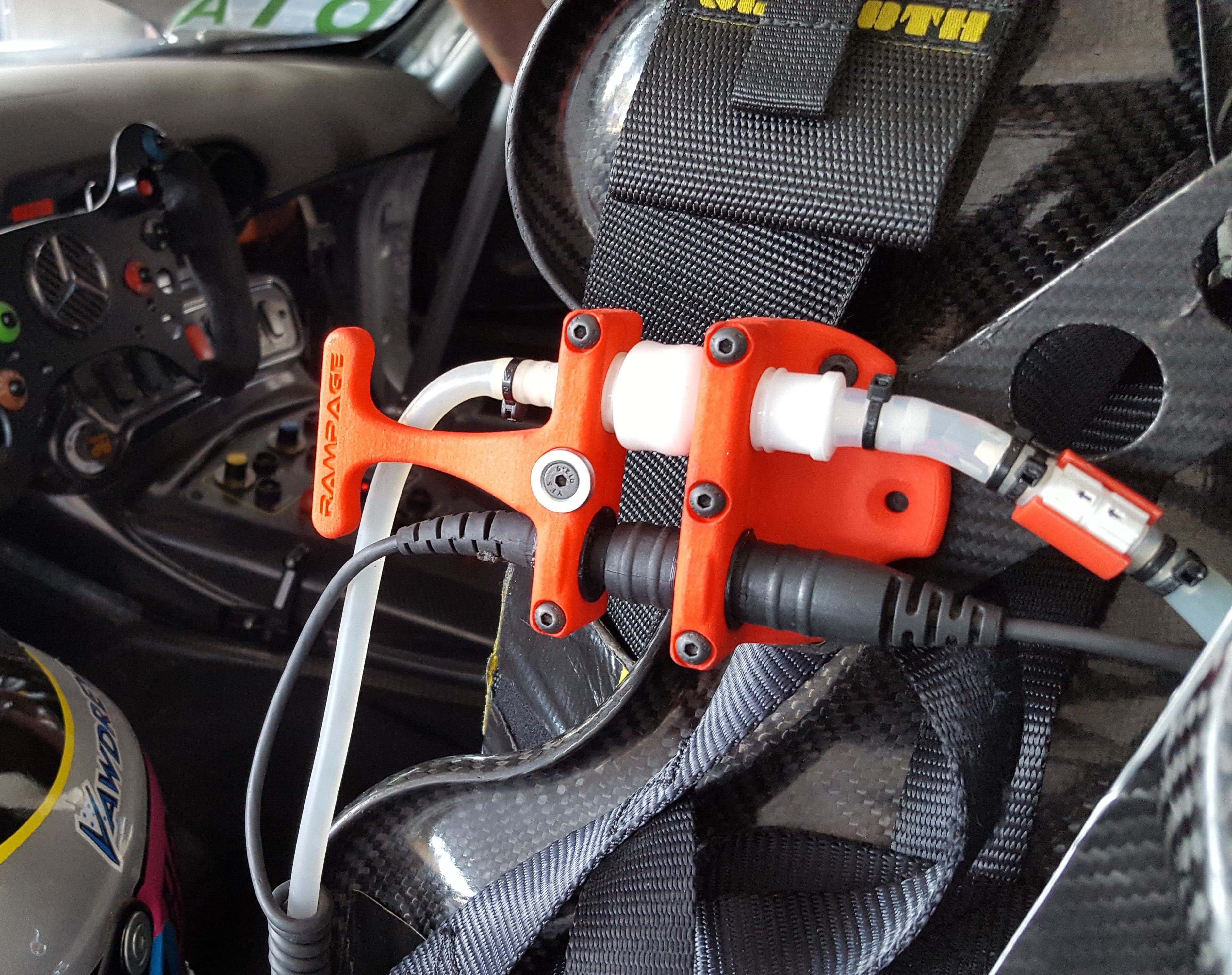 Race car Drink system Hydration Thirst Refreshment Water bottle Fluid intake Sports drink Performance Endurance Speed Mechanism Tubing Nozzle Driver Cockpit Fuel Pit stop Racing technology Sports equipment